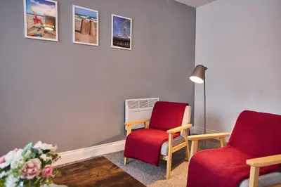 two chairs and a lamp in a waiting room at Host & Stay - Sandcastle Apartment in Blackpool