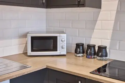 a microwave on a counter in a kitchen at Host & Stay - Sandcastle Apartment in Blackpool