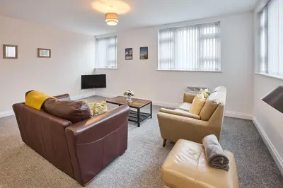 a living room with two couches and a table at Host & Stay - Promenade Suite in Blackpool