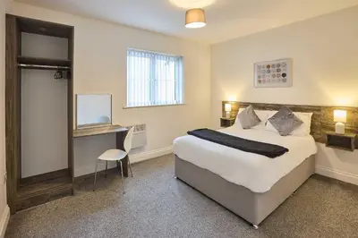 a bedroom with a bed and a desk and a window at Host & Stay - Tower Suite in Blackpool