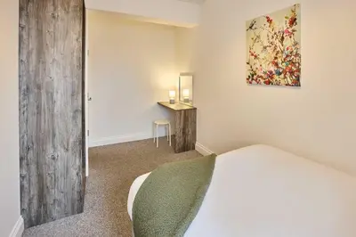 a bedroom with a bed and a table in it at Host & Stay - Tower Suite in Blackpool