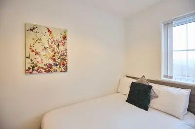 a bedroom with a bed and a painting on the wall at Host & Stay - Tower Suite in Blackpool