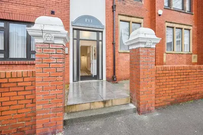 an entrance to a brick building with a phone booth at Host & Stay - Tower Suite in Blackpool