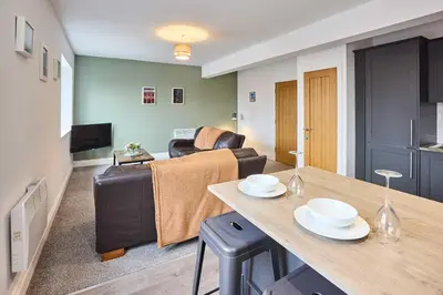 a living room with a couch and a table at Host & Stay - Tower Suite in Blackpool