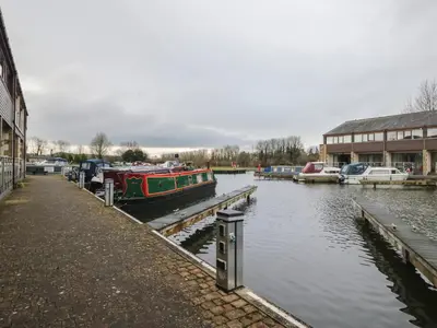 a boat is docked at a dock next to a building at 6 Swan House in Carnforth