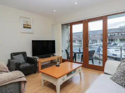 a living room with a television and a table at 6 Swan House in Carnforth