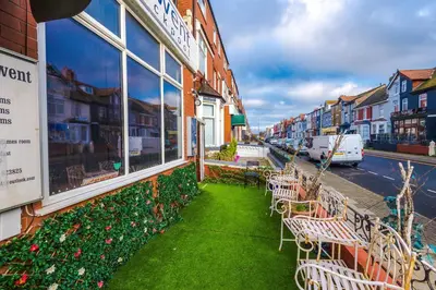 a row of tables and chairs outside of a building at Derwent Holiday Hotel in Blackpool