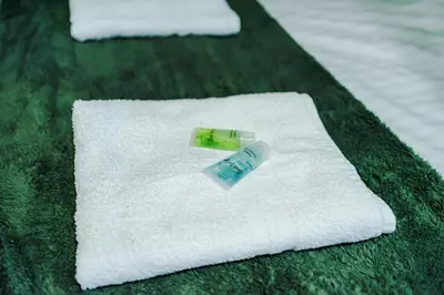 two white towels with a condom on top of them at Derwent Holiday Hotel in Blackpool
