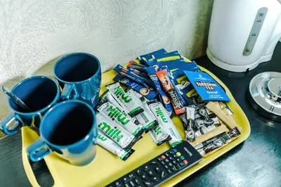 a table with a tray of candy and a remote control at Derwent Holiday Hotel in Blackpool