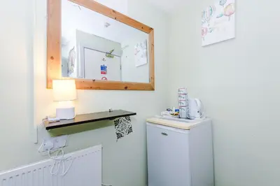 a bathroom with a sink and a mirror at Derwent Holiday Hotel in Blackpool