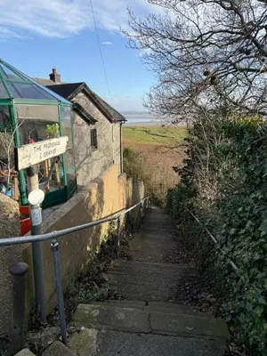 a stairway leading up to a building on a hill at Seaside escape near Cartmel and Grange in Kents Bank