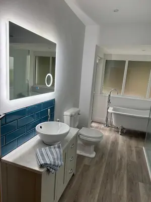 a bathroom with a sink and a tub and a toilet at Seaside escape near Cartmel and Grange in Kents Bank