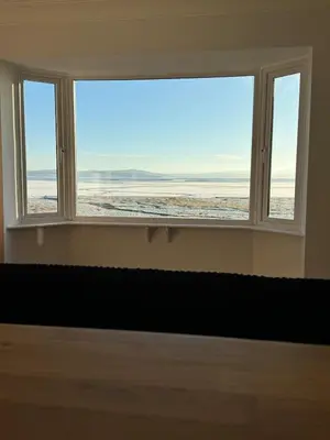 a window in a room with a view of the ocean at Seaside escape near Cartmel and Grange in Kents Bank