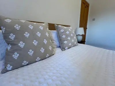 a bed with two pillows on top of it at Modernised fisherman's house near Lytham centre in Brown Moss Side
