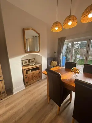 a dining room with a table and a mirror at Modernised fisherman's house near Lytham centre in Brown Moss Side