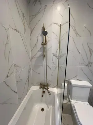 a white bath tub in a bathroom with a toilet at Modernised fisherman's house near Lytham centre in Brown Moss Side
