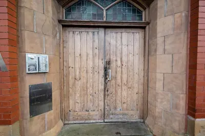 a wooden door on the side of a building at Luna Church 5 Blackpool in Blackpool