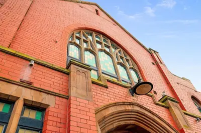 a red brick building with a large window on it at Luna Church 5 Blackpool in Blackpool