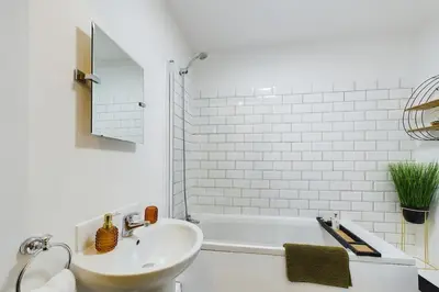 a white bathroom with a sink and a tub at Luna Church 5 Blackpool in Blackpool