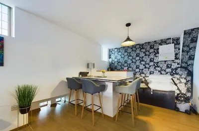 a kitchen with a counter and stools in a room at Luna Church 5 Blackpool in Blackpool