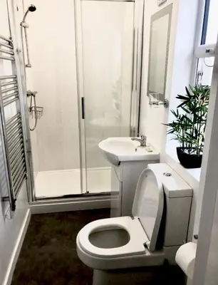a bathroom with a toilet and a sink and a shower at Cherish Lewis Hotel Blackpool in Blackpool