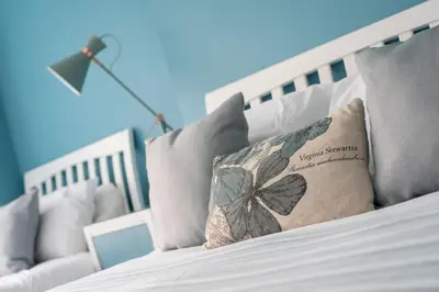 a white bed with a butterfly pillow on it at Cherish Lewis Hotel Blackpool in Blackpool