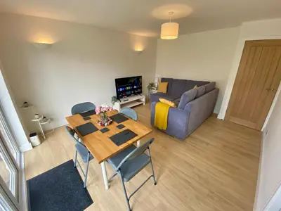 a living room with a table and a couch at Modern Bungalow Family Friendly and Eco-Conscious in Southport