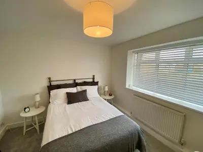 a bedroom with a bed and a window at Modern Bungalow Family Friendly and Eco-Conscious in Southport
