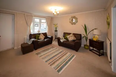 a living room with two couches and a rug at Spacious 3BR House By Kammili Properties in Westhoughton - Free Parking in Westhoughton