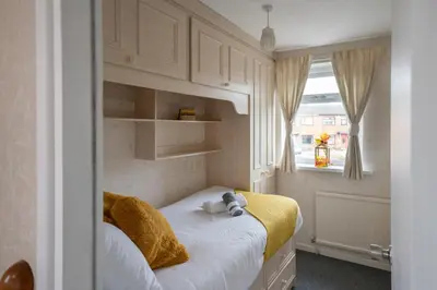 a bedroom with a bed with a stuffed animal on it at Spacious 3BR House By Kammili Properties in Westhoughton - Free Parking in Westhoughton