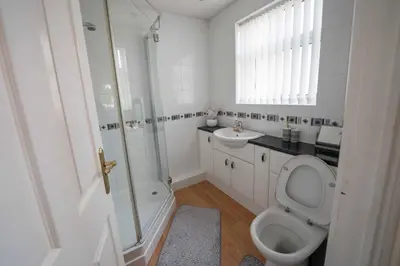 a bathroom with a toilet and a sink and a shower at Spacious 3BR House By Kammili Properties in Westhoughton - Free Parking in Westhoughton