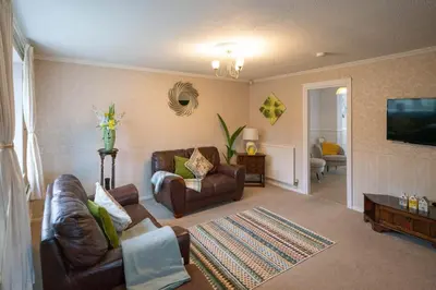 a living room with two couches and a television at Spacious 3BR House By Kammili Properties in Westhoughton - Free Parking in Westhoughton