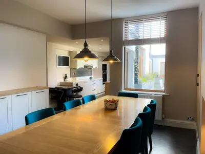 a kitchen and dining room with a wooden table and chairs at Design-inspired, Stunning Clitheroe Home in Clitheroe