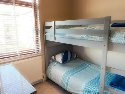 a bedroom with bunk beds in a room with a window at Design-inspired, Stunning Clitheroe Home in Clitheroe