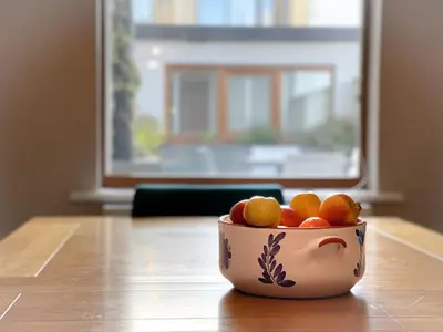 a bowl of fruit sitting on top of a table at Design-inspired, Stunning Clitheroe Home in Clitheroe