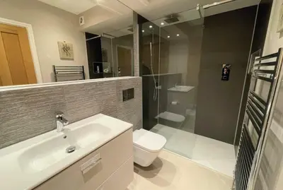 a bathroom with a sink and a toilet and a shower at Design-inspired, Stunning Clitheroe Home in Clitheroe
