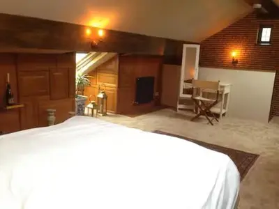 a bedroom with a bed and a desk in a room at Artie's Lodge in Arnside