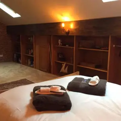 a bedroom with a bed with towels on it at Artie's Lodge in Arnside