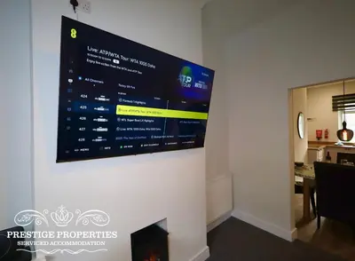 a large screen hanging on a wall in a room at 30 Telford St by Prestige Properties SA in Barrow in Furness