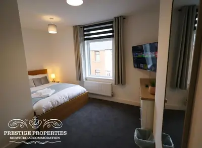 a hotel room with a bed and a window at 30 Telford St by Prestige Properties SA in Barrow in Furness