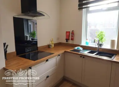 a kitchen with a counter and a sink and a window at 30 Telford St by Prestige Properties SA in Barrow in Furness