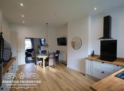 a kitchen and living room with a table and a dining room at 30 Telford St by Prestige Properties SA in Barrow in Furness