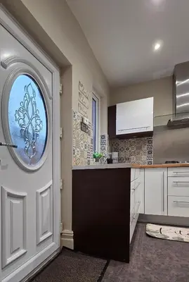 a kitchen with a door with a window at 3 bedroom modern newly renovated house in Preston in Preston