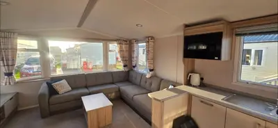 a living room with a couch and a tv at Mason's Morecambe Memories in Heysham