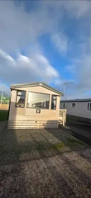 a small house sitting on the side of a road at Mason's Morecambe Memories in Heysham