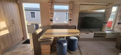 a living room with a table and a television at Mason's Morecambe Memories in Heysham