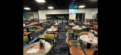 a restaurant with tables and chairs in a room at Mason's Morecambe Memories in Heysham