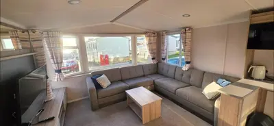 a living room with a couch and a tv at Mason's Morecambe Memories in Heysham