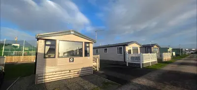 a couple of tiny houses in a parking lot at Mason's Morecambe Memories in Heysham