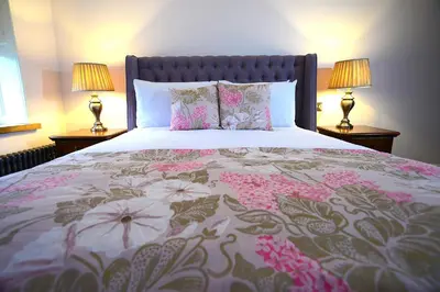 a bedroom with a large bed with flowers on it at The Morecambe Hotel in Morecambe